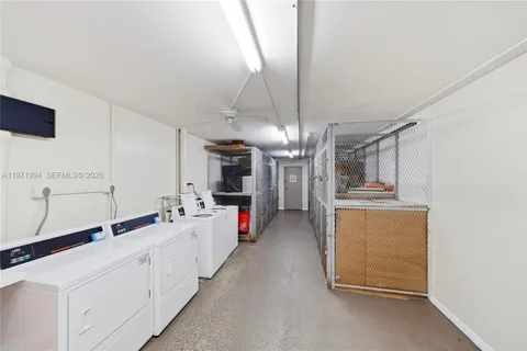 a large white kitchen with cabinets a sink and dishwasher