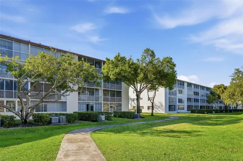 a front view of a building with a garden