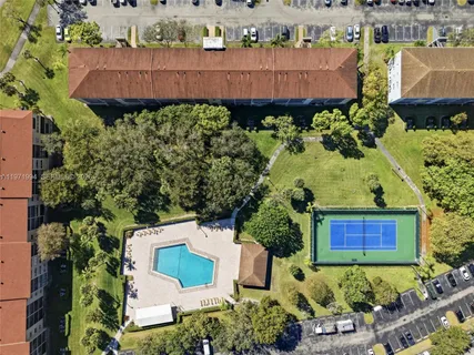 an aerial view of a house with a yard and garden