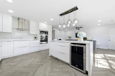 a kitchen with cabinets a sink and stainless steel appliances