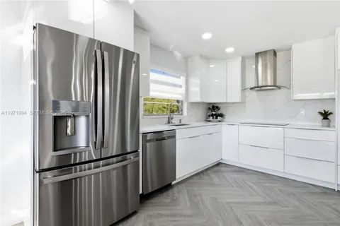 a kitchen with stainless steel appliances granite countertop a refrigerator sink and cabinets