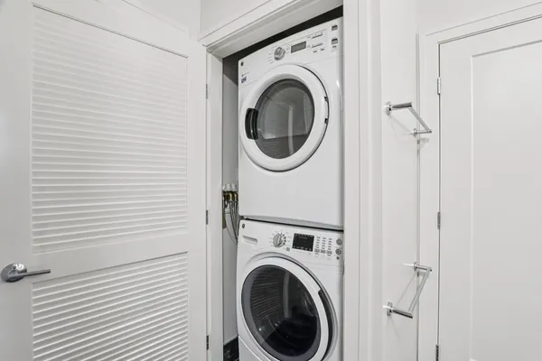 a view of a hallway with washer and dryer