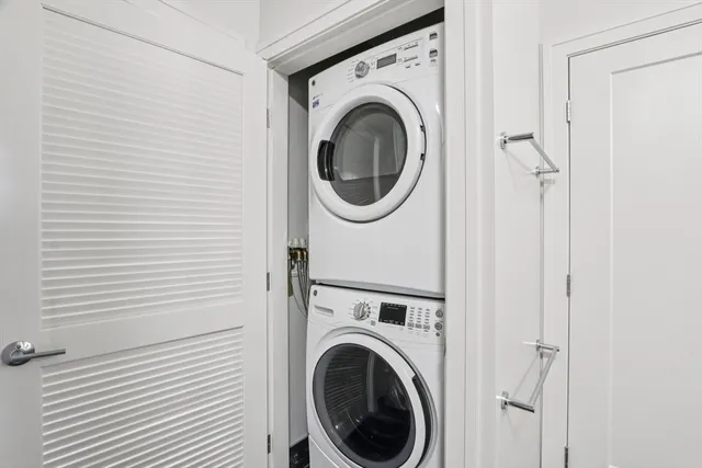 a view of a hallway with washer and dryer