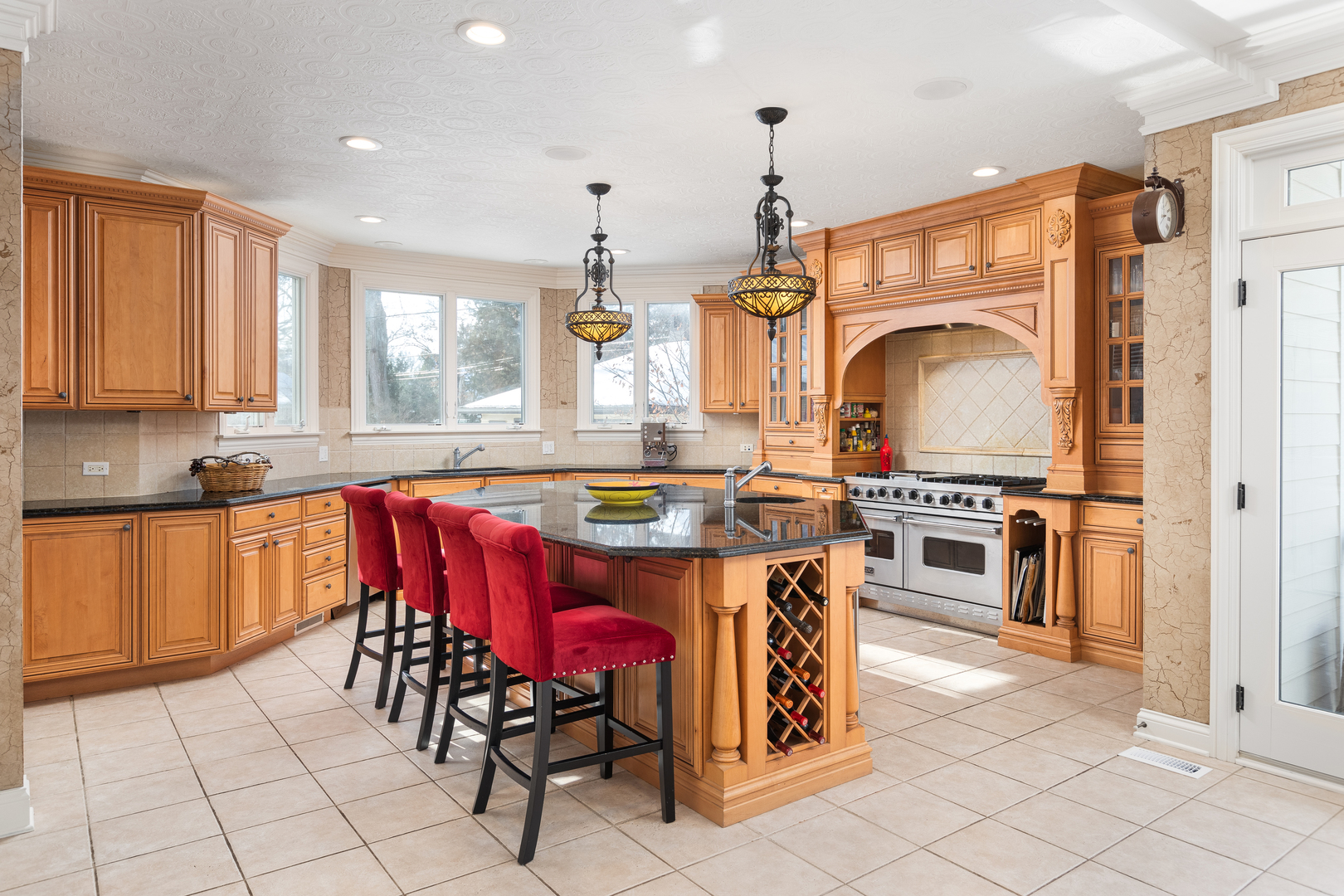 655 Sunset Drive Naperville, IL 60540 - Photo 14 of 61 a kitchen with stainless steel appliances kitchen island granite countertop a stove a sink a dining table and chairs with wooden floor