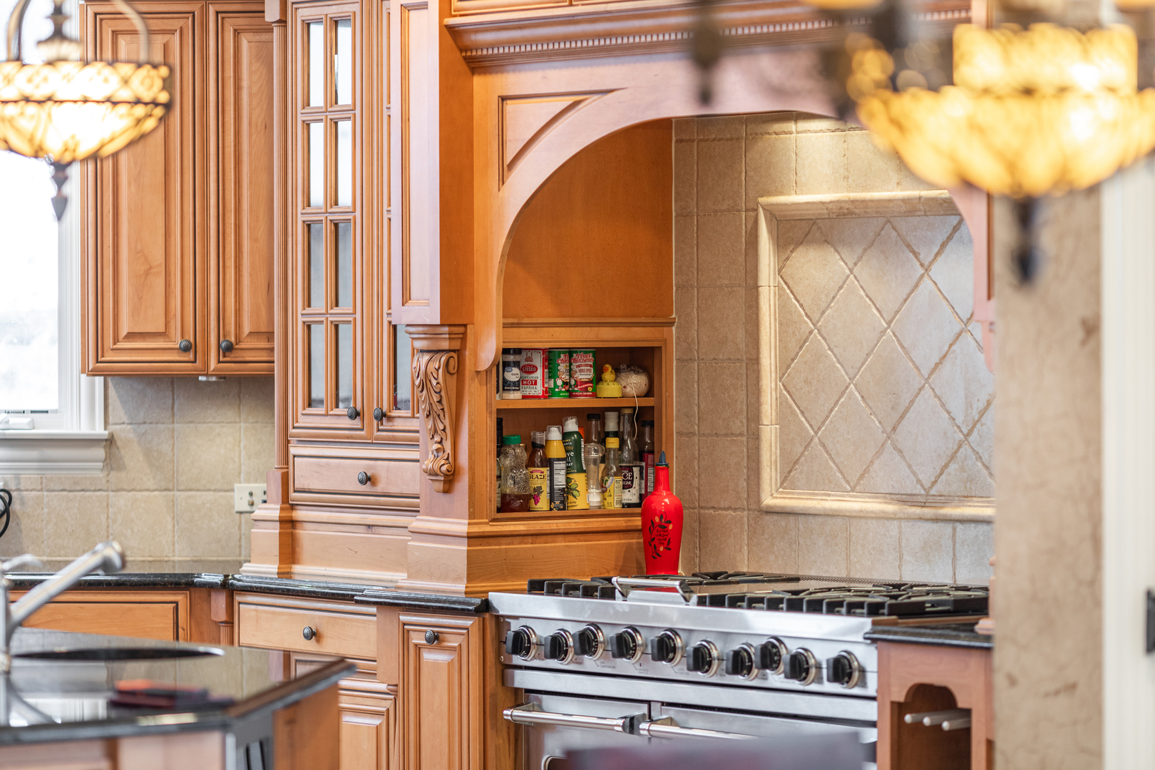 655 Sunset Drive Naperville, IL 60540 - Photo 16 of 61 a kitchen with blue cabinets and a stove top oven