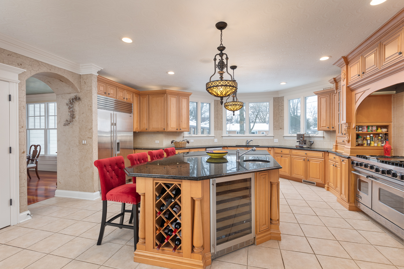 655 Sunset Drive Naperville, IL 60540 - Photo 21 of 61 a kitchen with stainless steel appliances granite countertop a stove a sink a refrigerator and chairs