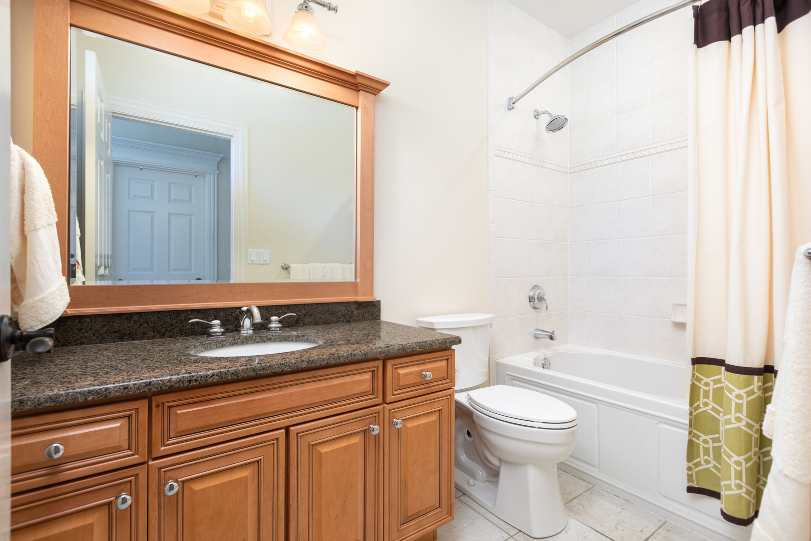 655 Sunset Drive Naperville, IL 60540 - Photo 39 of 61 a bathroom with a granite countertop sink a toilet and bathtub