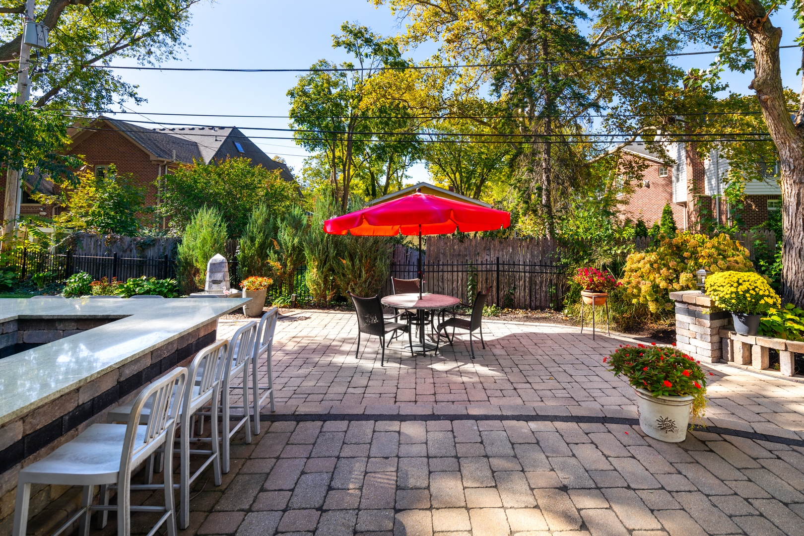 655 Sunset Drive Naperville, IL 60540 - Photo 48 of 61 a view of a patio with a table and chairs under an umbrella
