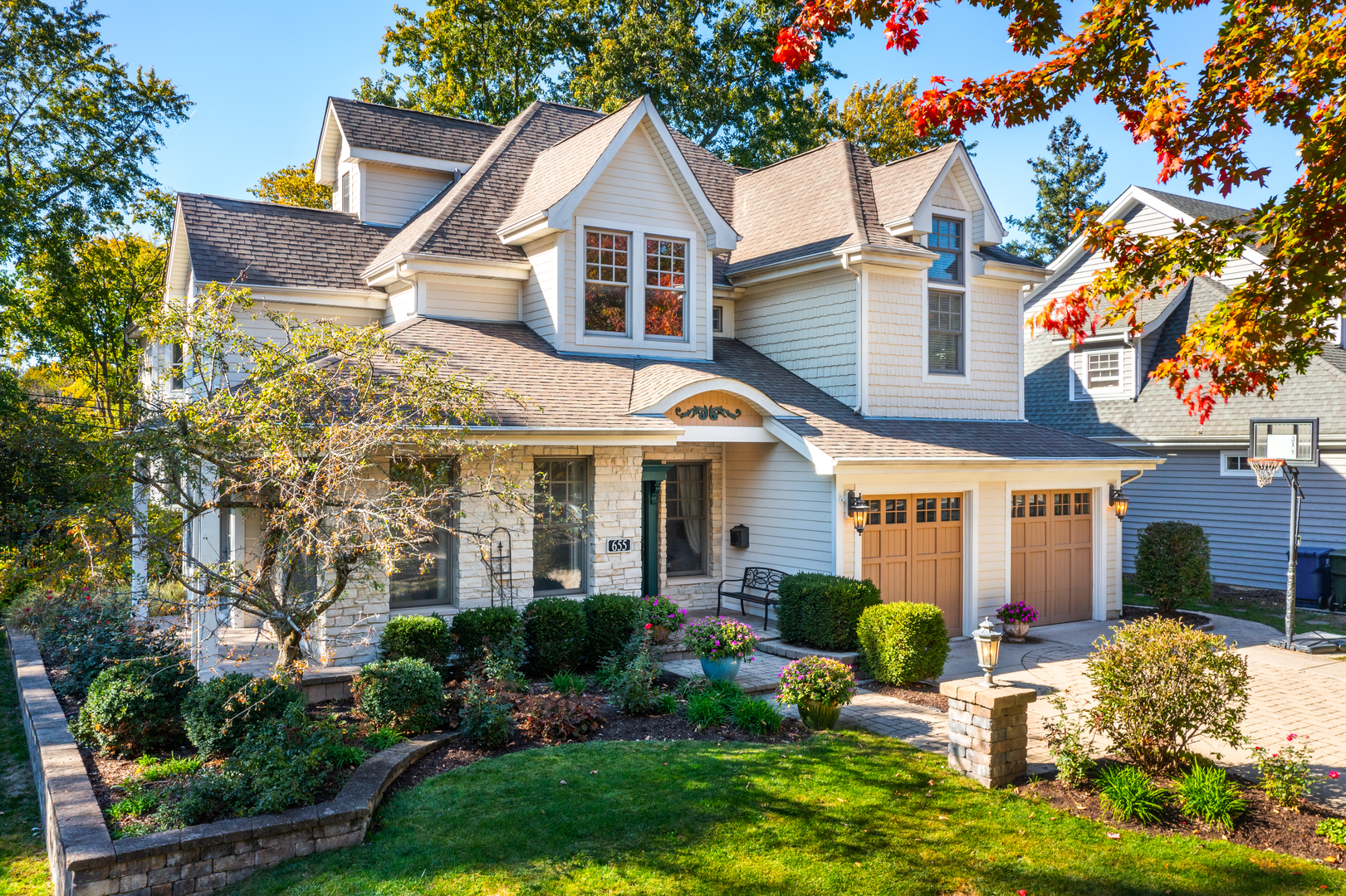655 Sunset Drive Naperville, IL 60540 - Photo 54 of 61 a front view of a house with a yard and potted plants