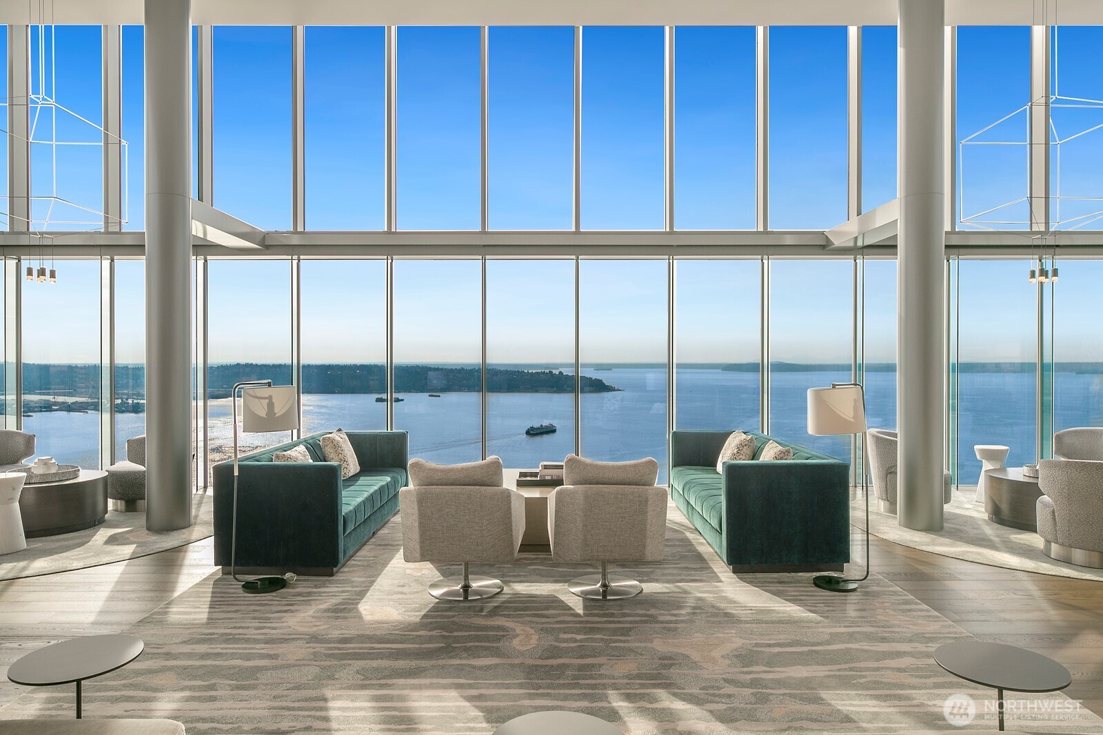 a living room with furniture large windows and a rug