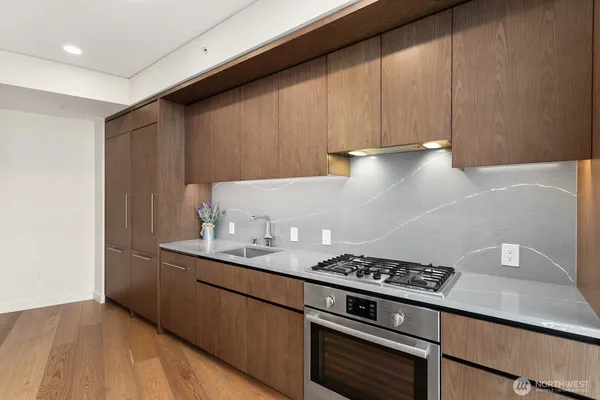 a kitchen with granite countertop a stove and a sink