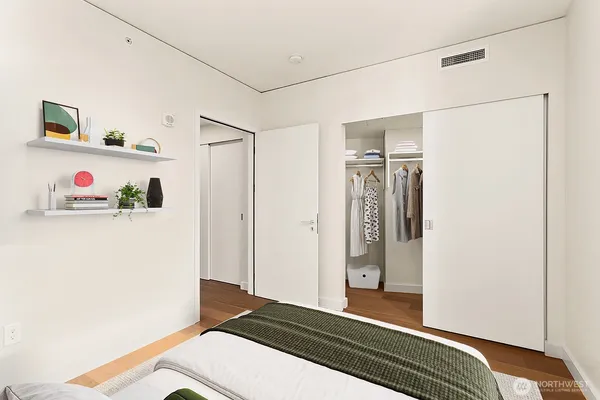 a bedroom with a bed and cabinets