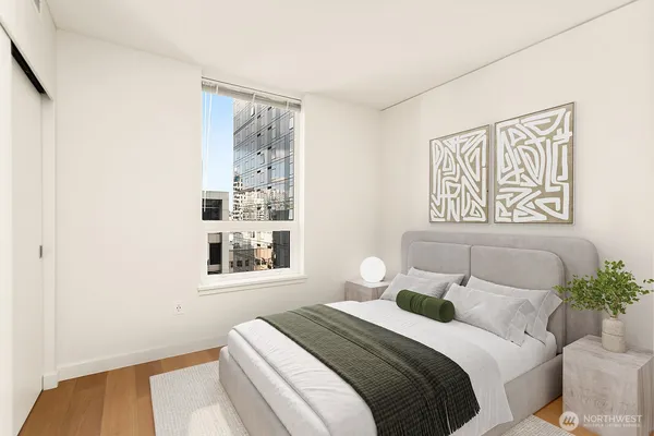 a bedroom with a bed and a painting on the wall