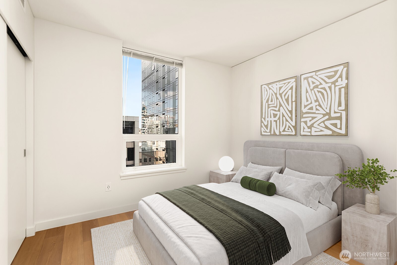 121 Stewart Street, Unit 1502 Seattle, WA 98101 - Photo 10 of 22 a bedroom with a bed and a painting on the wall