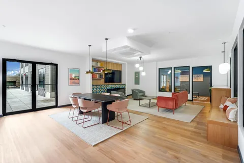a living room with furniture a flat screen tv and a large window