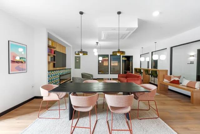 a kitchen with a dining table chairs and white cabinets