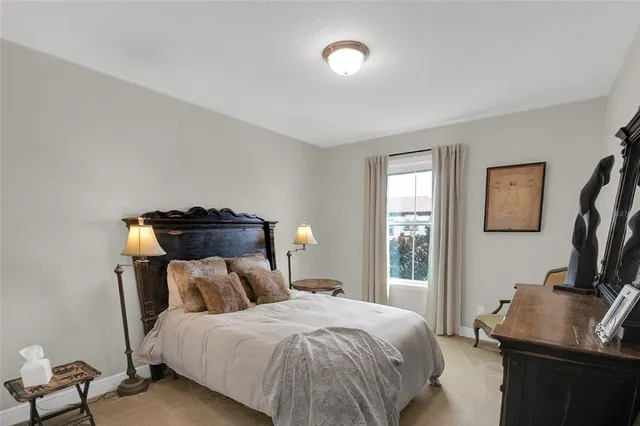 a bed sitting in a bedroom next to a window