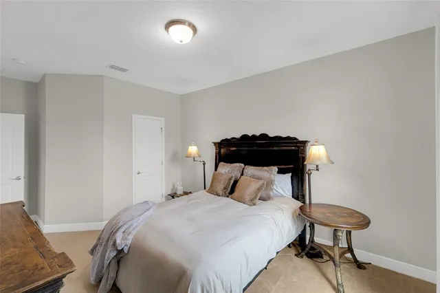 a bedroom with a bed and a chair