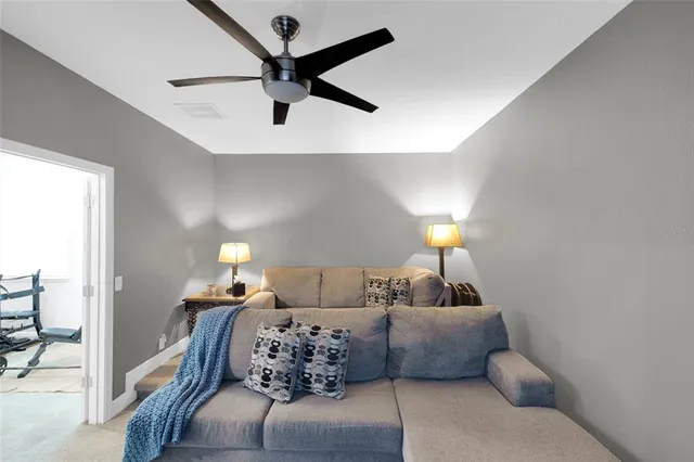 a bedroom with furniture and a lamp