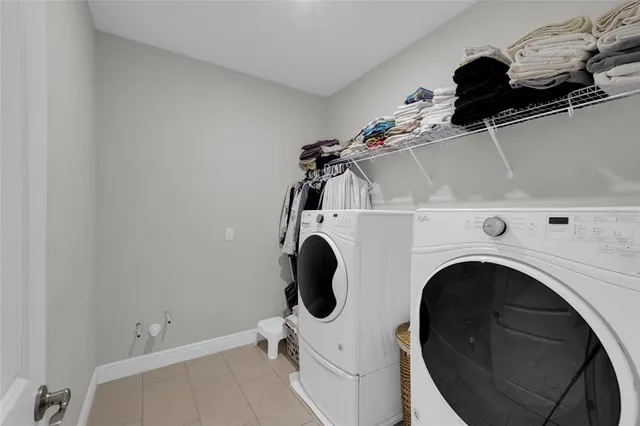 a bedroom with furniture and a large window