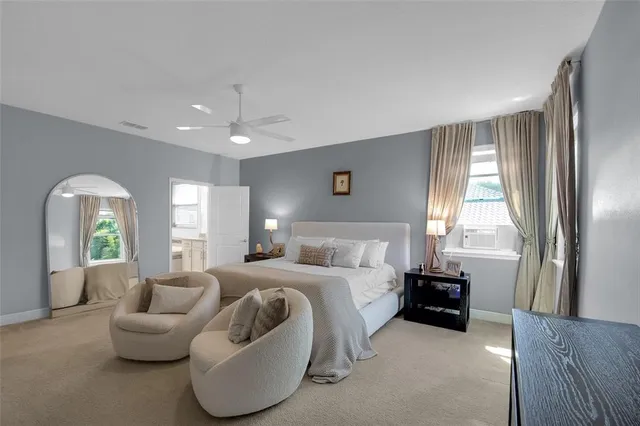 a spacious bedroom with a bed and a flat screen tv