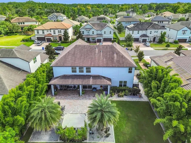 an aerial view of multiple houses with yard