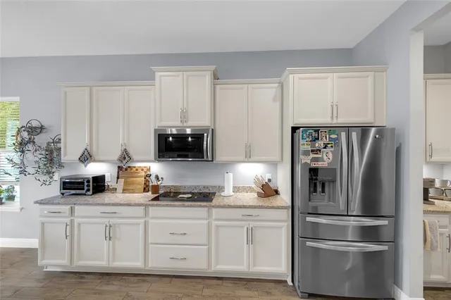 a kitchen with appliances a sink and cabinets