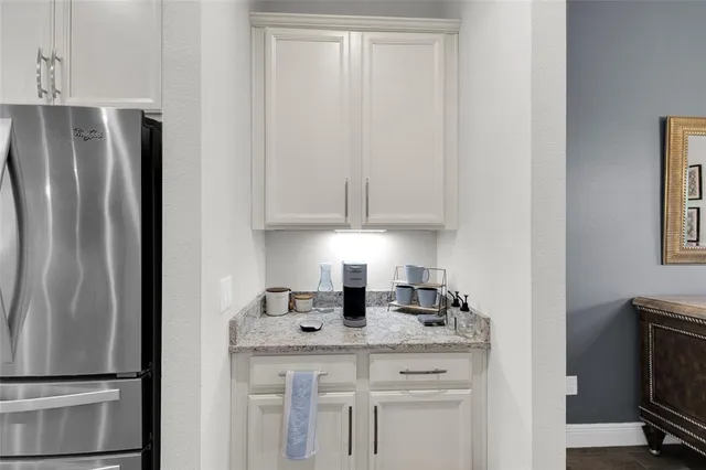 a kitchen with appliances a sink and cabinets