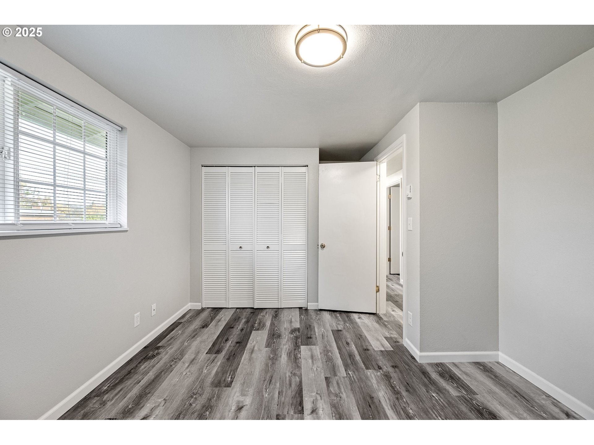 450 U Street Springfield, OR 97477 - Photo 12 of 25 a view of an empty room with wooden floor and a window