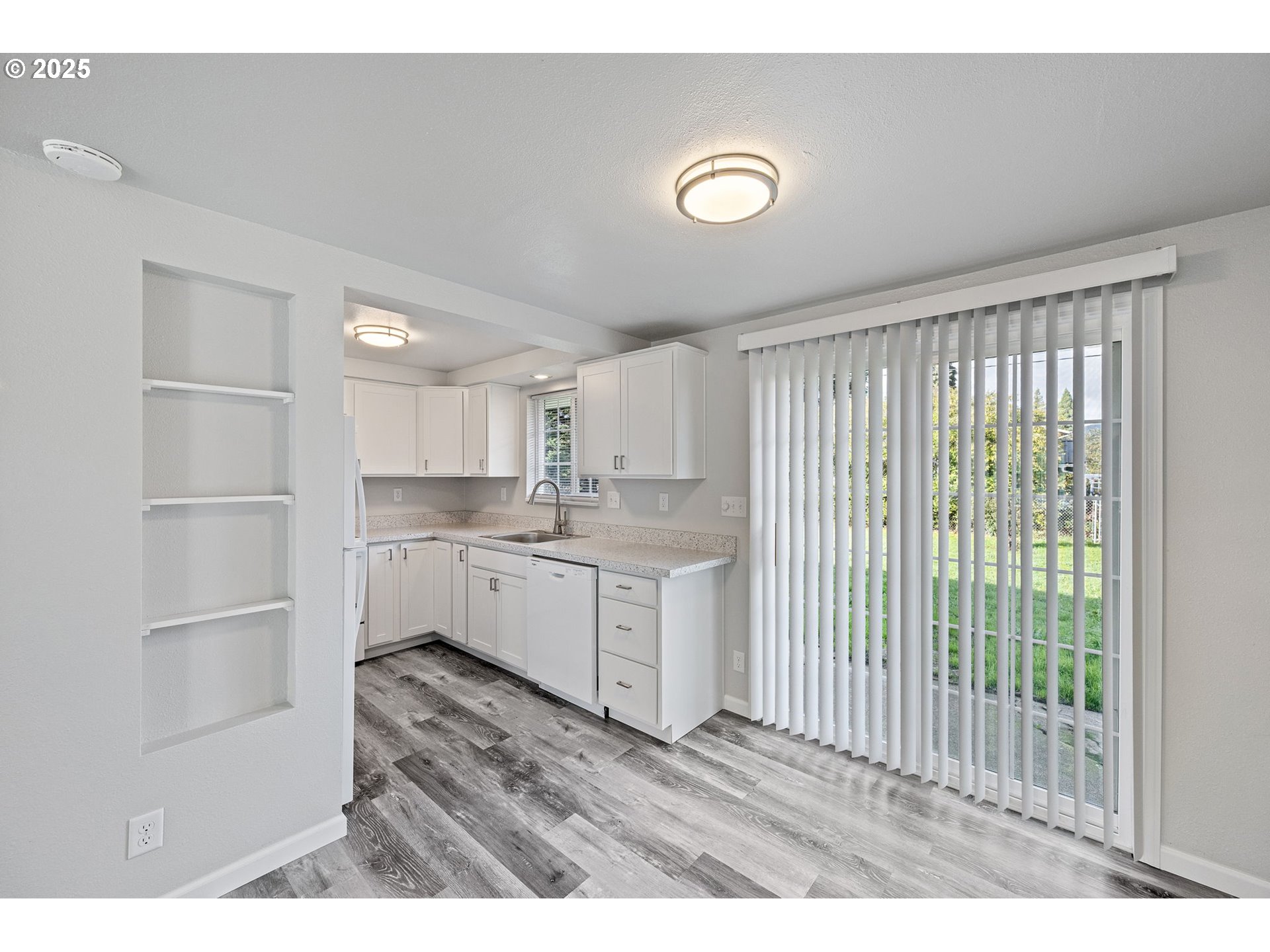 450 U Street Springfield, OR 97477 - Photo 18 of 25 a kitchen with white cabinets and wooden floor