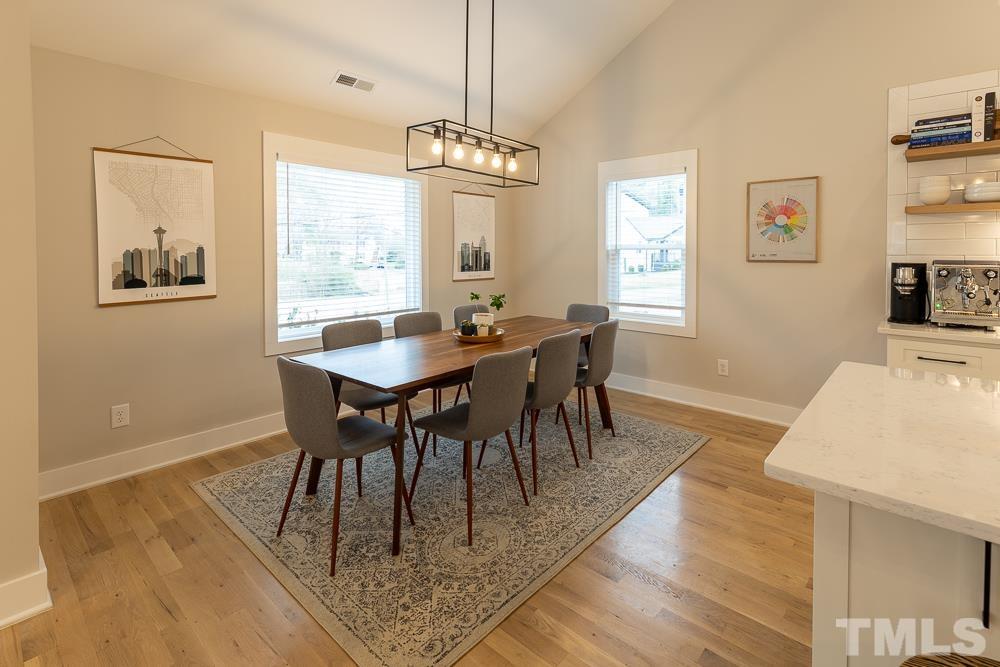 2200 Sheffield Road Raleigh, NC 27610 - Photo 11 of 44 a view of a dining room with furniture window and wooden floor