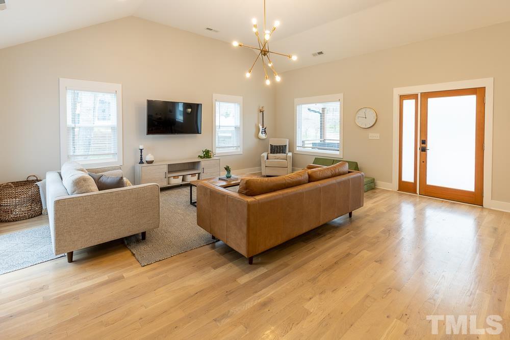 2200 Sheffield Road Raleigh, NC 27610 - Photo 13 of 44 a living room with furniture and a flat screen tv