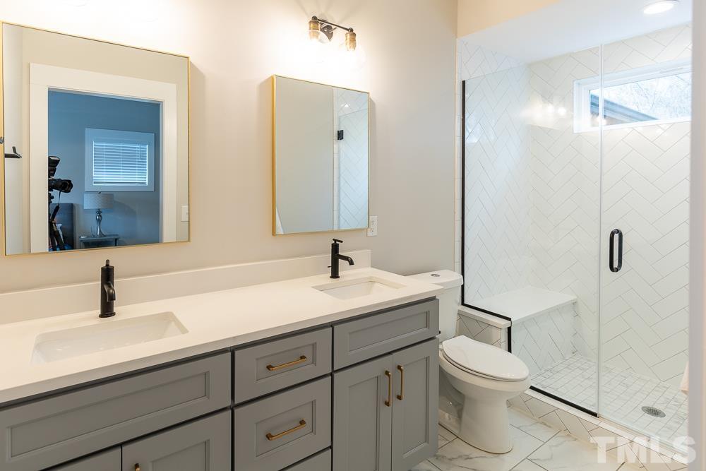 2200 Sheffield Road Raleigh, NC 27610 - Photo 21 of 44 a bathroom with a toilet sink and mirror