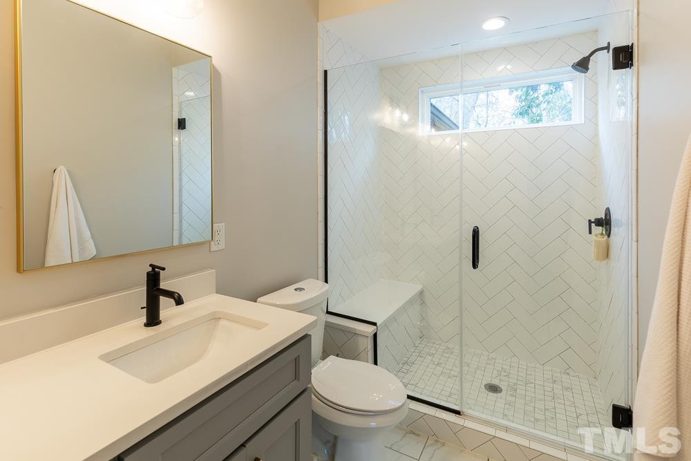 2200 Sheffield Road Raleigh, NC 27610 - Photo 22 of 44 a bathroom with a sink a toilet and shower
