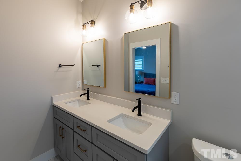 2200 Sheffield Road Raleigh, NC 27610 - Photo 23 of 44 a bathroom with a sink and a mirror