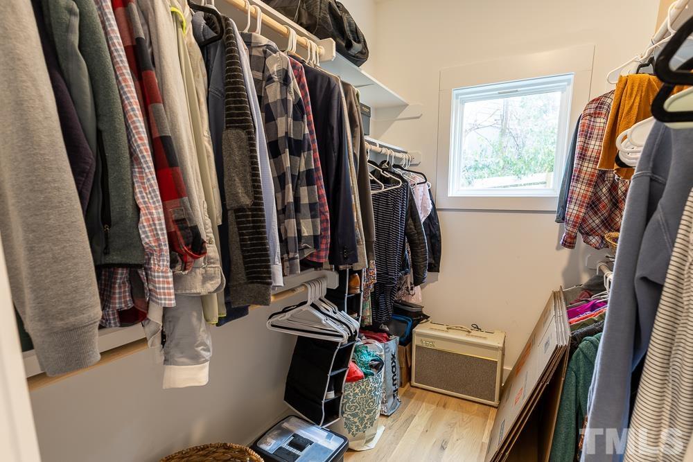 2200 Sheffield Road Raleigh, NC 27610 - Photo 25 of 44 a view of walk in closet with clothes and shoes