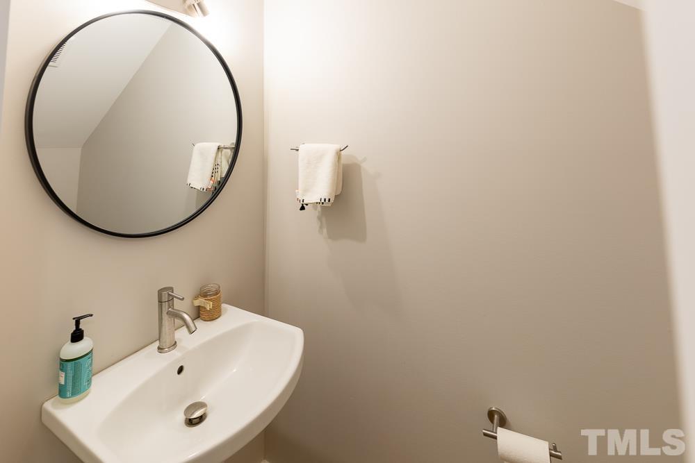2200 Sheffield Road Raleigh, NC 27610 - Photo 27 of 44 a bathroom with a sink and a mirror