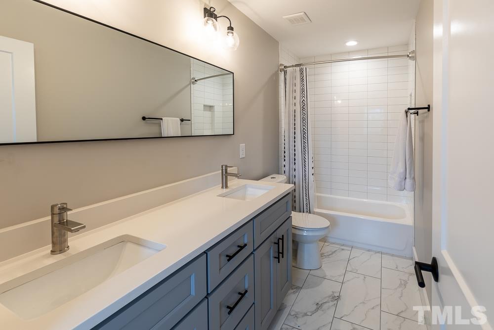 2200 Sheffield Road Raleigh, NC 27610 - Photo 29 of 44 a bathroom with a sink a toilet and shower