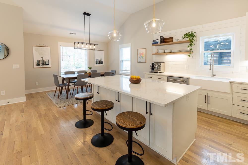 2200 Sheffield Road Raleigh, NC 27610 - Photo 6 of 44 a kitchen with a table chairs sink and stove
