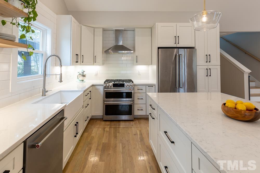 2200 Sheffield Road Raleigh, NC 27610 - Photo 7 of 44 a kitchen with stainless steel appliances a sink stove and refrigerator