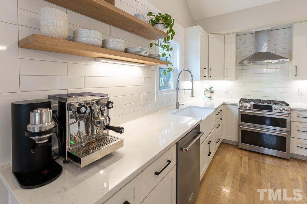 2200 Sheffield Road Raleigh, NC 27610 - Photo 8 of 44 a kitchen with stainless steel appliances granite countertop a stove and a refrigerator