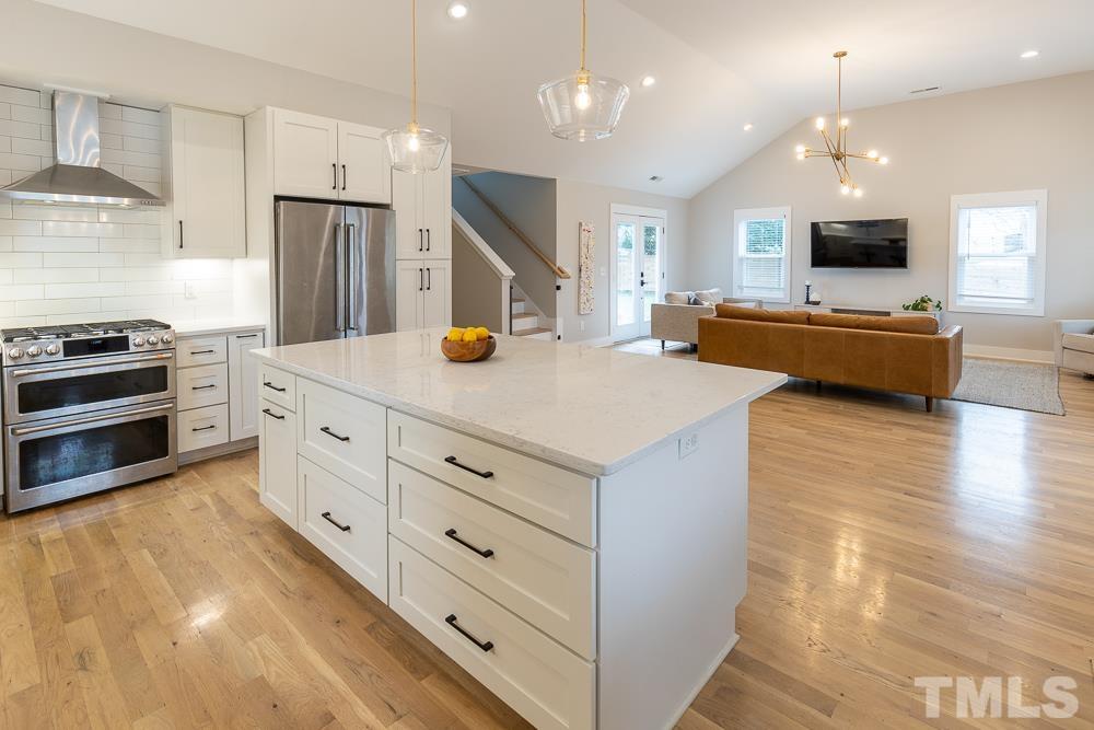 2200 Sheffield Road Raleigh, NC 27610 - Photo 9 of 44 a kitchen with stainless steel appliances kitchen island granite countertop a stove and a sink