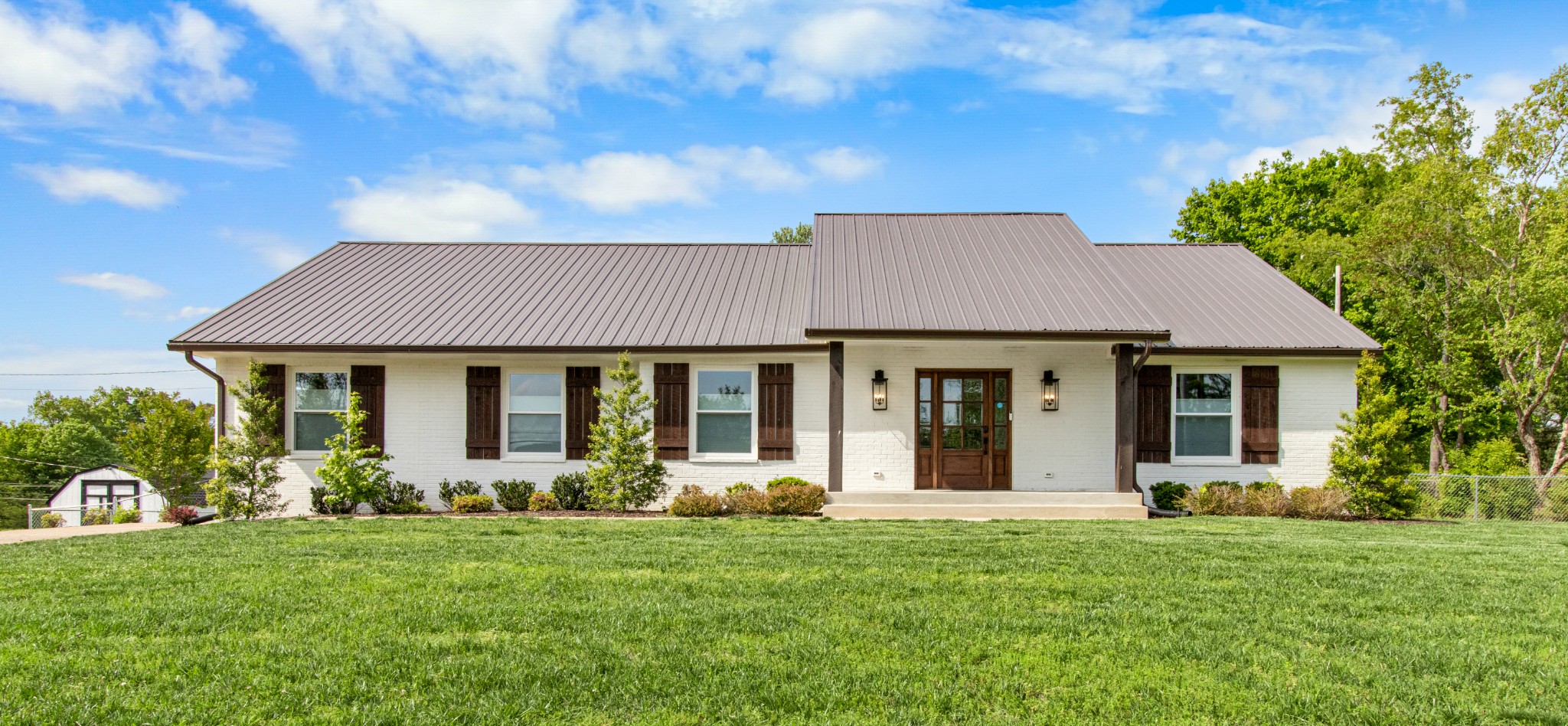 a front view of a house with a garden