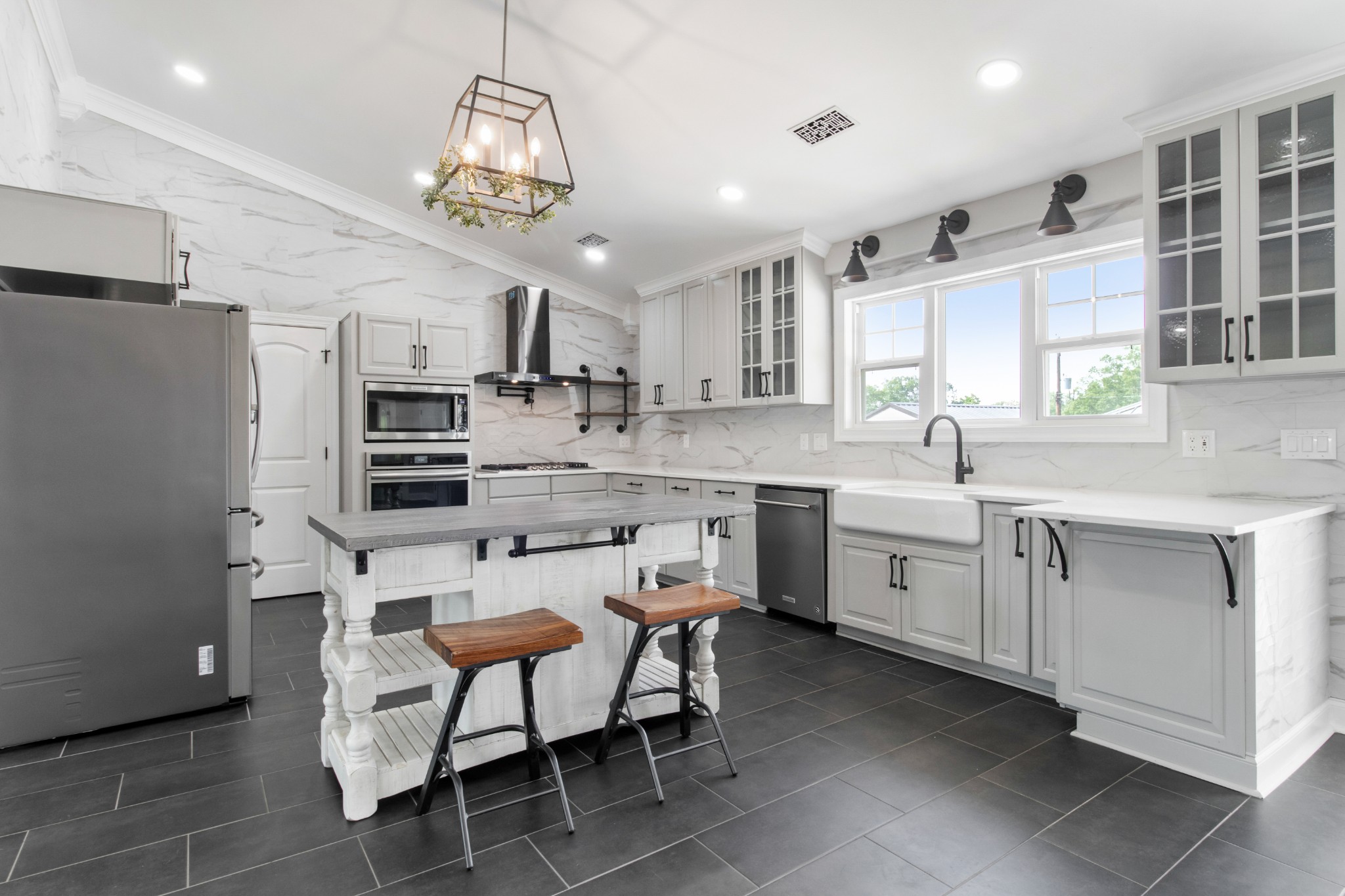 209 Hawkins Road Clarksville, TN 37040 - Photo 11 of 39 a kitchen with stainless steel appliances a dining table chairs sink and cabinets