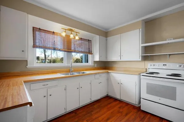 a kitchen with a sink stove and cabinets