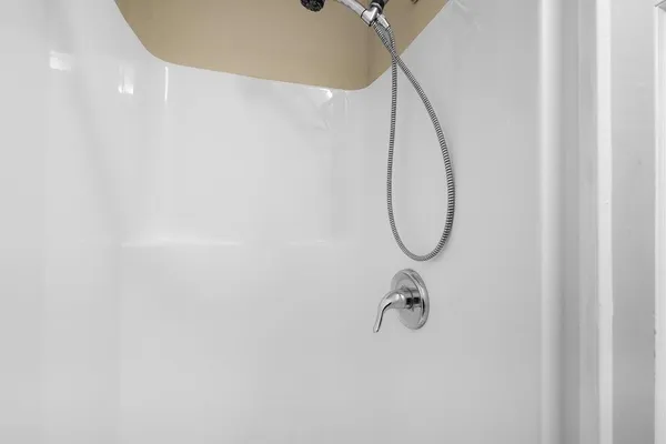 a bathroom with a shower and a mirror