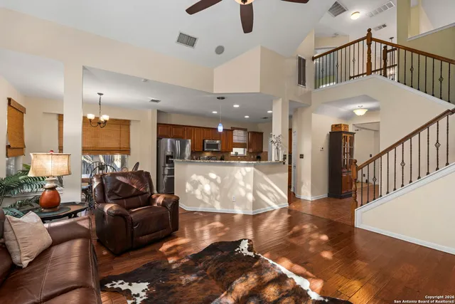 a living room with furniture or kitchen view and a wooden floor