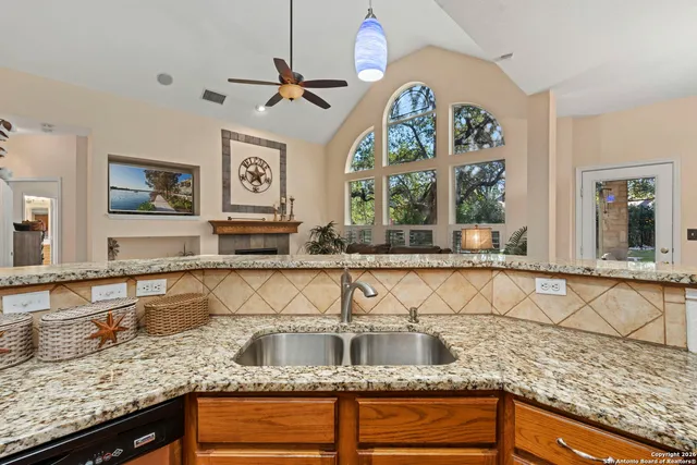 a kitchen with stainless steel appliances granite countertop a sink and a granite counter tops