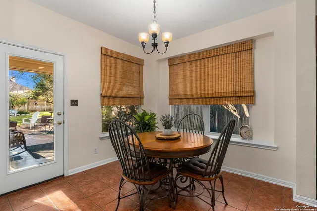 a view of a dining room with furniture and chandelier