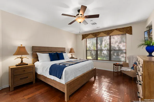 a bedroom with a bed and a large window